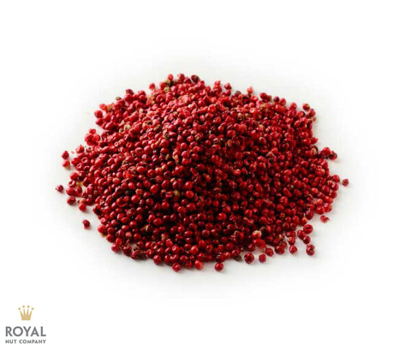 white background with a pile of red pink peppercorn